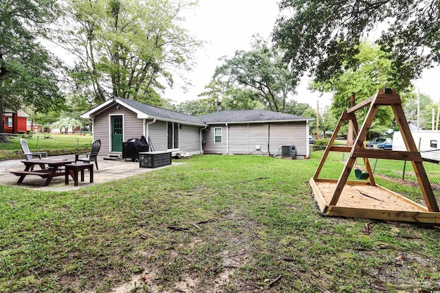 view of yard featuring a patio, a playground, and central air condition unit