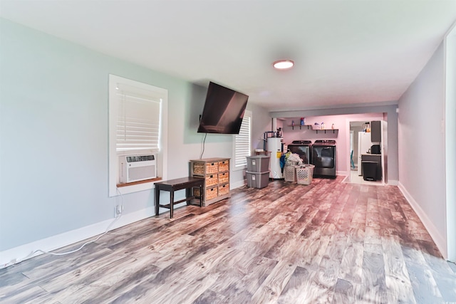 living room with gas water heater, light wood-type flooring, independent washer and dryer, and cooling unit