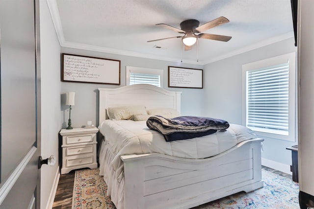 bedroom featuring hardwood / wood-style floors, multiple windows, ceiling fan, and crown molding