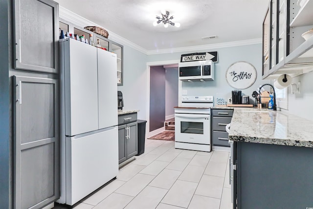 kitchen with sink, gray cabinetry, white appliances, crown molding, and light stone countertops