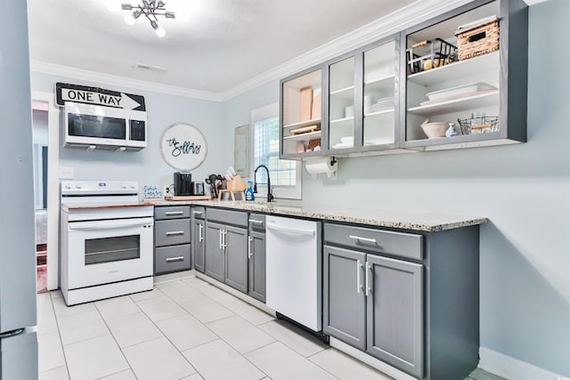 kitchen featuring sink, gray cabinetry, white appliances, crown molding, and light stone countertops