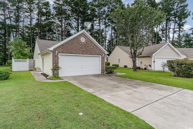 single story home featuring a garage and a front lawn