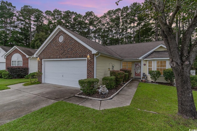 ranch-style home with a garage and a yard