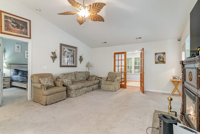 living room with light carpet, lofted ceiling, french doors, and ceiling fan