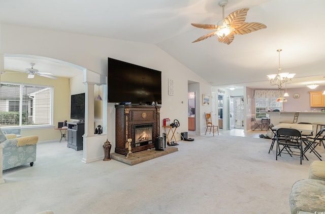 carpeted living room featuring ceiling fan and lofted ceiling