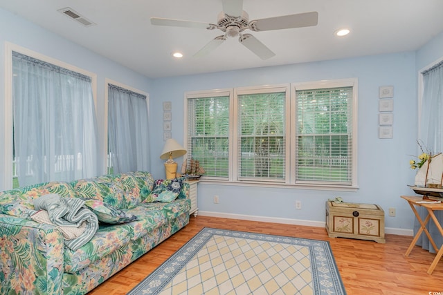 living room with hardwood / wood-style flooring and ceiling fan