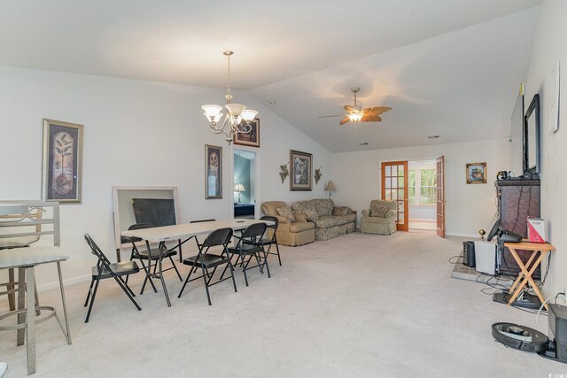 interior space featuring ceiling fan with notable chandelier and vaulted ceiling