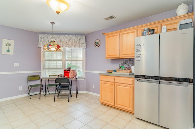 kitchen with pendant lighting, stainless steel fridge, and light brown cabinets