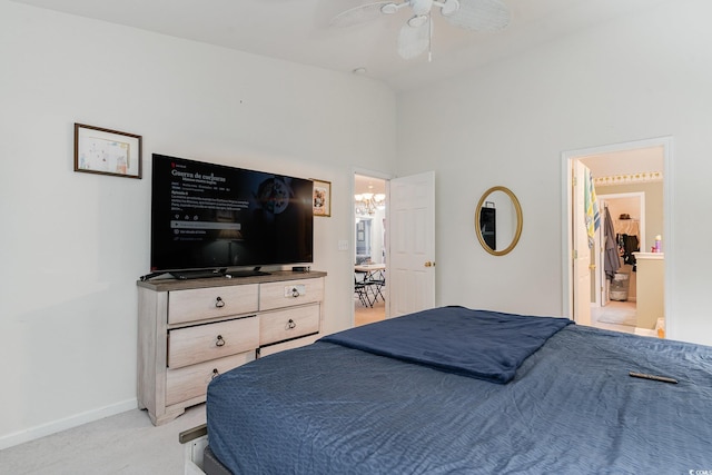 bedroom with light carpet, ceiling fan with notable chandelier, and lofted ceiling