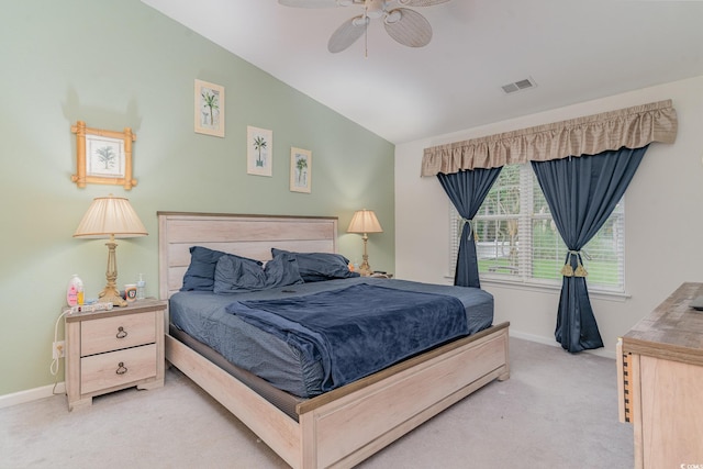 bedroom featuring vaulted ceiling, light colored carpet, and ceiling fan