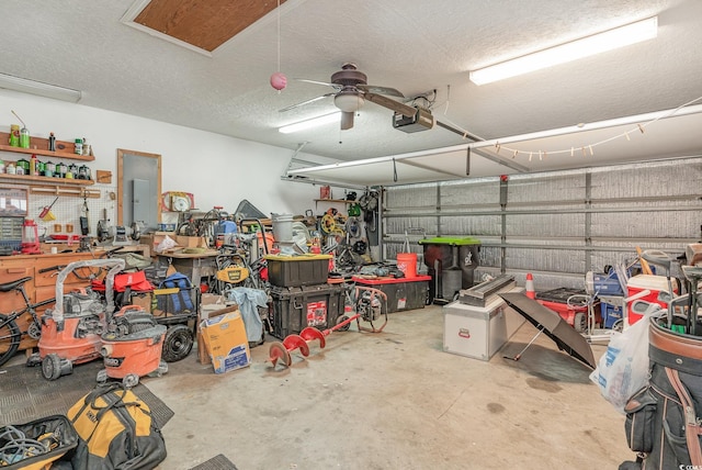 garage with ceiling fan, a garage door opener, and a workshop area