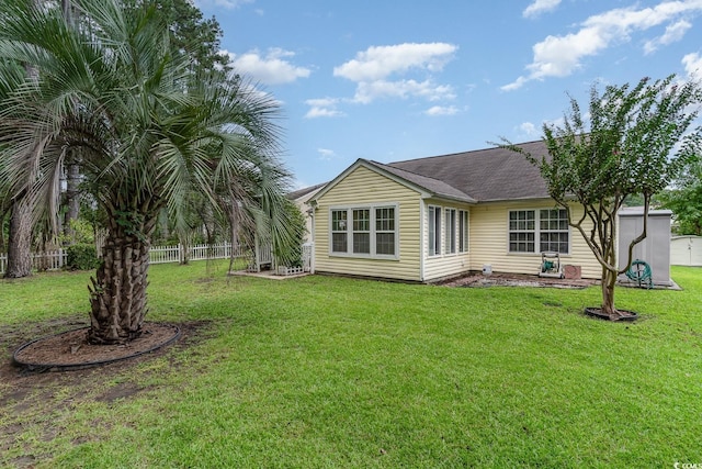 rear view of house with a yard