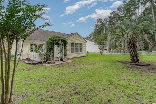 back of property featuring a yard