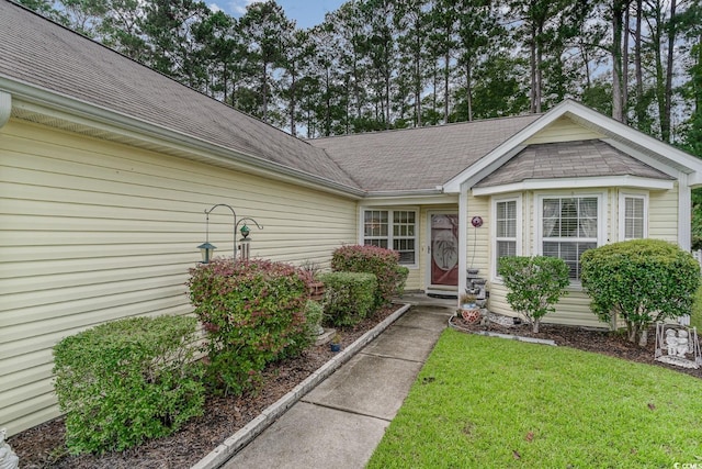 doorway to property featuring a lawn