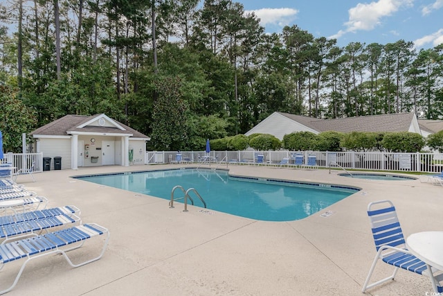 view of pool with a community hot tub and a patio