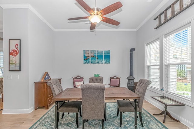 dining space with light hardwood / wood-style floors, ceiling fan, and crown molding