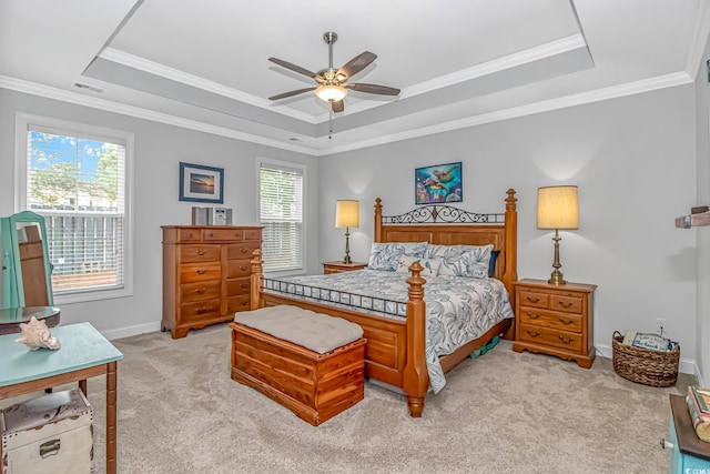 carpeted bedroom featuring ceiling fan, a raised ceiling, and multiple windows