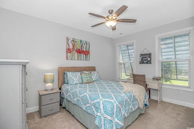 bedroom featuring ceiling fan and light colored carpet