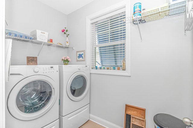 laundry room with washing machine and clothes dryer