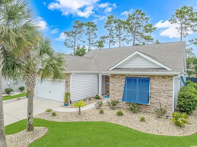 view of front of house featuring a garage and a front lawn