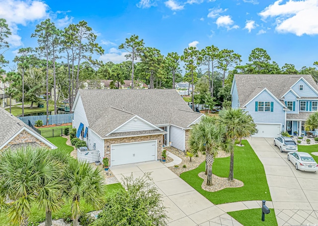 view of front of house featuring a garage and a front lawn