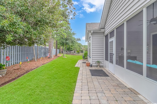 view of yard with a sunroom and a patio area