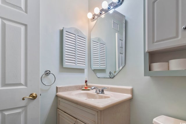 bathroom featuring vanity and toilet