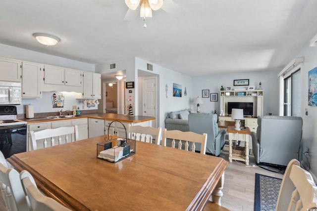 5905 S Kings Hwy Unit 416-B, Myrtle Beach, SC 29575 - dining space with light wood-style floors and ceiling fan