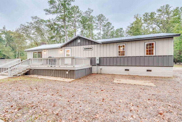 back of house featuring a wooden deck