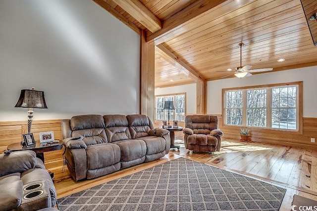 living room with hardwood / wood-style flooring, lofted ceiling with beams, ceiling fan, and plenty of natural light