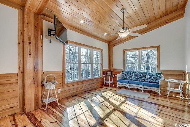 sitting room with ceiling fan, light wood-type flooring, lofted ceiling, and wooden ceiling