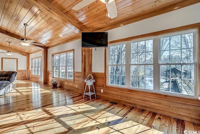 unfurnished sunroom featuring wood ceiling, vaulted ceiling with beams, and ceiling fan