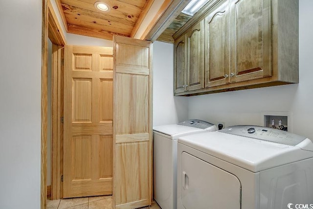 clothes washing area with light tile patterned flooring, cabinets, independent washer and dryer, and wooden ceiling