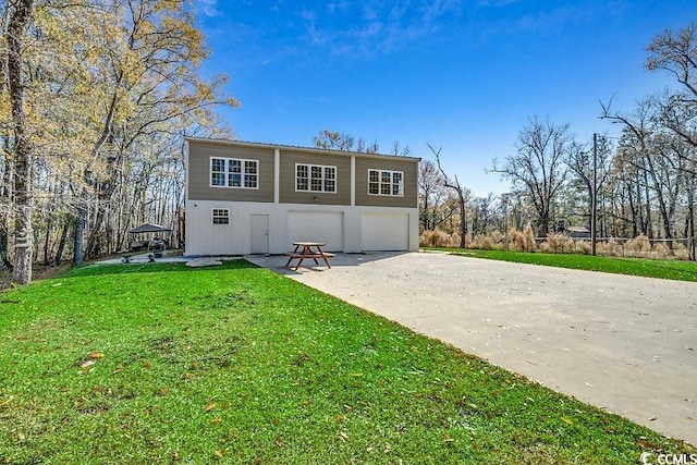 view of property with a front lawn and a garage