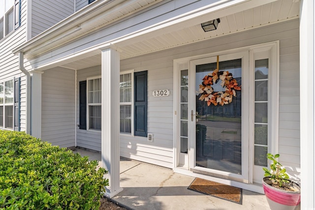 view of exterior entry featuring a porch