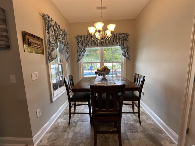 dining room featuring an inviting chandelier, visible vents, and baseboards