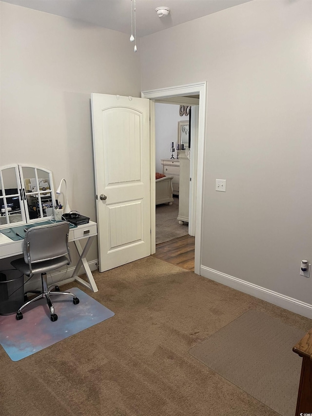 home office featuring carpet flooring and baseboards