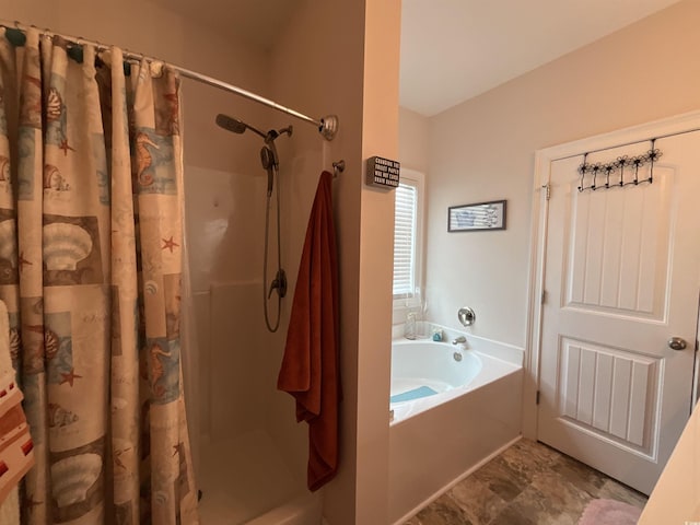 bathroom with a garden tub and a shower stall