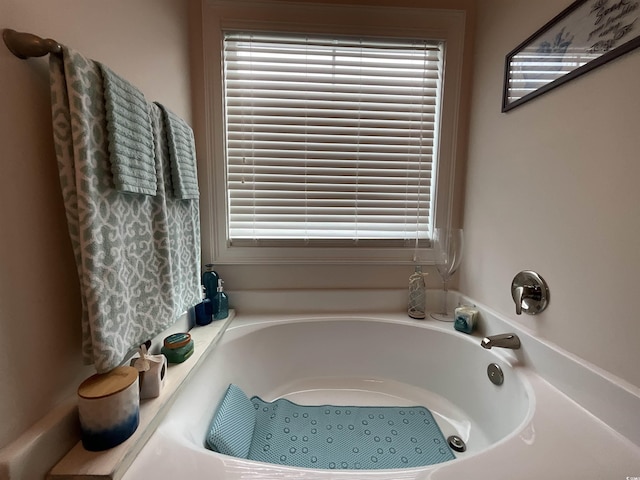 full bath featuring a bath and a wealth of natural light