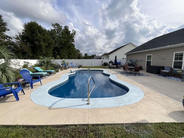 view of swimming pool with a patio area, a fenced backyard, and a fenced in pool