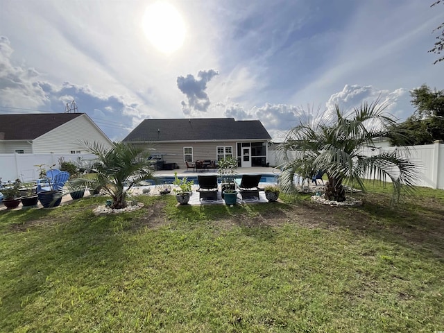 back of house with a yard, a patio, a fenced backyard, and a fenced in pool