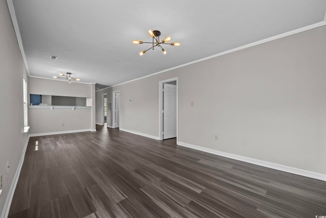 unfurnished living room featuring dark wood-type flooring, a textured ceiling, ornamental molding, and an inviting chandelier