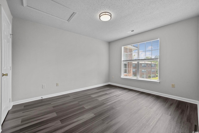 unfurnished room featuring a textured ceiling and dark hardwood / wood-style flooring