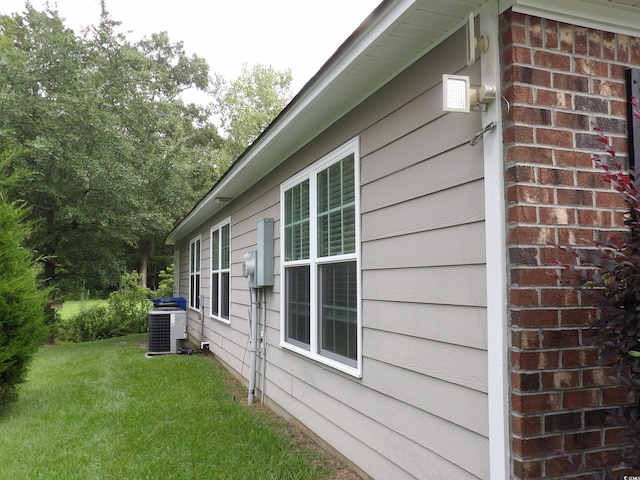 view of property exterior with a lawn