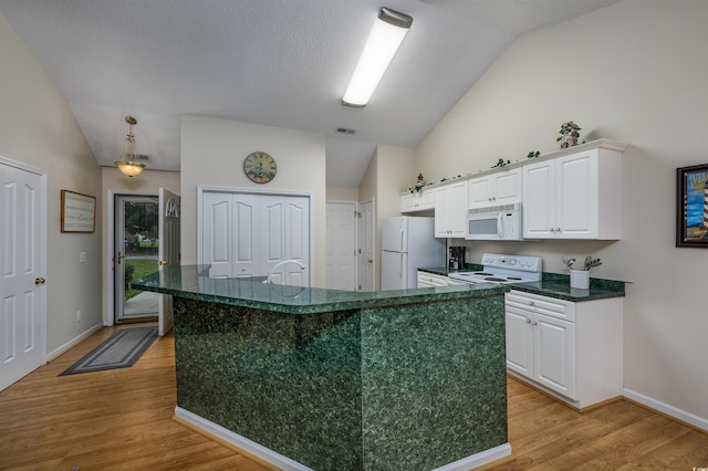 kitchen with light hardwood / wood-style flooring, vaulted ceiling, white appliances, and white cabinetry