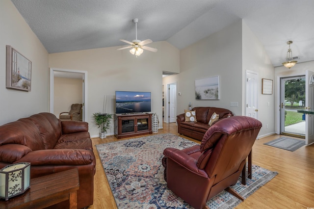 living room featuring high vaulted ceiling, ceiling fan, hardwood / wood-style flooring, and a textured ceiling