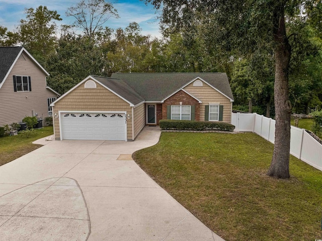 view of front of house with a garage and a front lawn