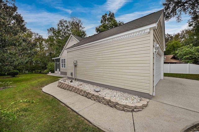 view of side of property with a garage and a yard