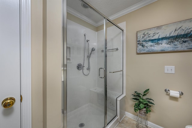 bathroom featuring ornamental molding, tile patterned flooring, a textured ceiling, and a shower with door