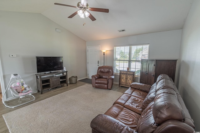 living room with wood-type flooring, lofted ceiling, and ceiling fan